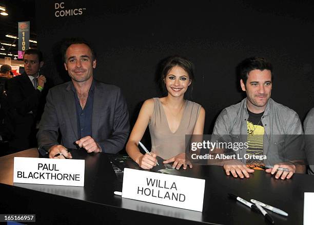 Actors Paul Blackthorne, Willa Holland and Colin Donnell of The WB's "Arrow" signs autographs at the DC Comics booth at WonderCon Anaheim 2013 - Day...