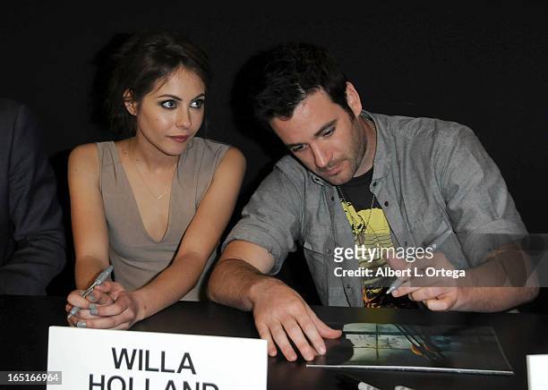 Actress Willa Holland and actor Colin Donnell of The WB's "Arrow" signs autographs at the DC Comics booth at WonderCon Anaheim 2013 - Day 3 held at...