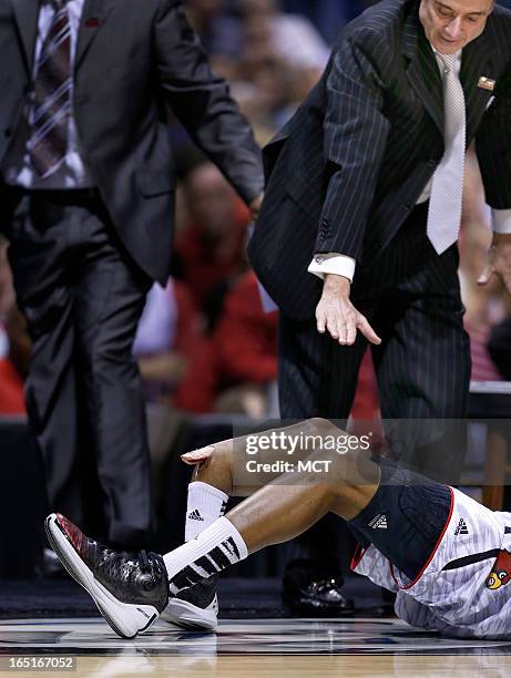 Louisville team members and head coach Rick Pitino rush off the bench as Louisville guard Kevin Ware has his right leg break in a gruesome accident...