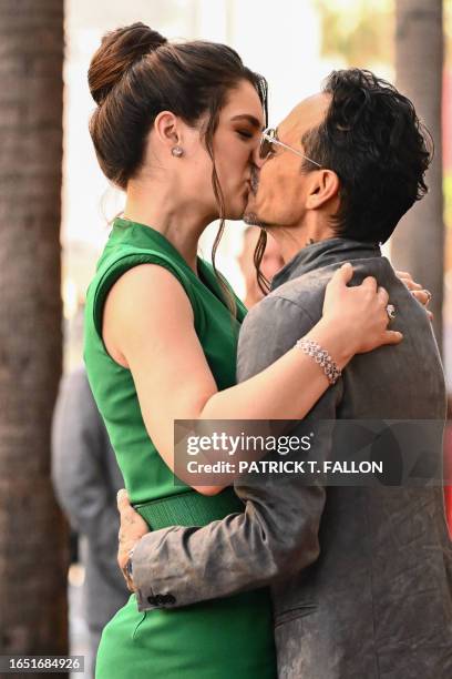 Singer Marc Anthony and his wife Paraguayan model Nadia Ferreira kiss as he receives a star on the Hollywood Walk of Fame during a ceremony in...