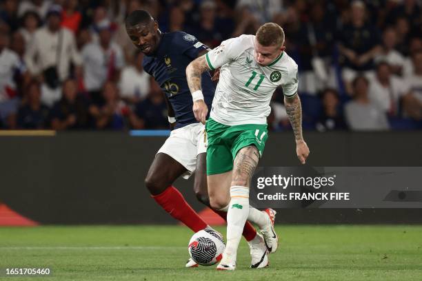 France's forward Marcus Thuram fights for the ball with Republic of Ireland's midfielder James McClean during the UEFA Euro 2024 football tournament...