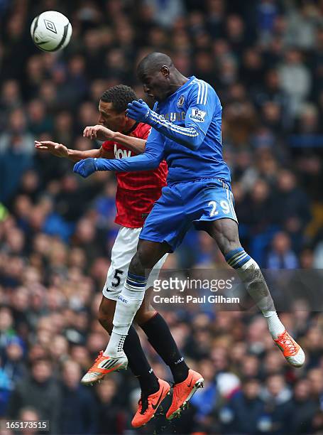 Demba Ba of Chelsea wins a header against Rio Ferdinand of Manchester United during the FA Cup with Budweiser Sixth Round Replay match between...