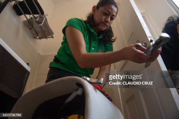 Mexican plumber Berenice Aparicio repairs a toilet at a private house in Mexico City on August 31, 2023. A female president in Mexico for the first...