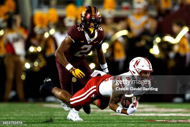 Isaiah Garcia-Castaneda of the Nebraska Cornhuskers catches a pass while Tre'Von Jones of the Minnesota Golden Gophers defends in the first half at...