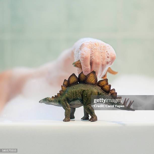 dinosaur toy at bath - dinosaur toy i stock pictures, royalty-free photos & images