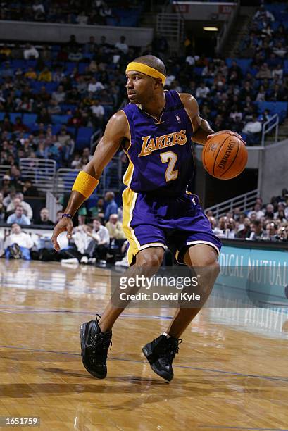 Guard Derek Fisher of the Los Angeles Lakers eyes the floor as he dribbles against the Cleveland Cavaliers during the game at Gund Arena on November...