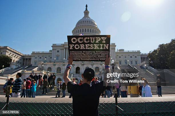 Jeremy Kung of South Australia, relays his messages to tourists on the west front of the Capitol during a protest on male circumcision.