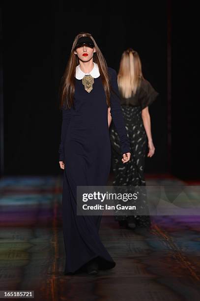 Model walks the runway at the Masha Kravtsova show during Mercedes-Benz Fashion Week Russia Fall/Winter 2013/2014 at Manege on April 1, 2013 in...