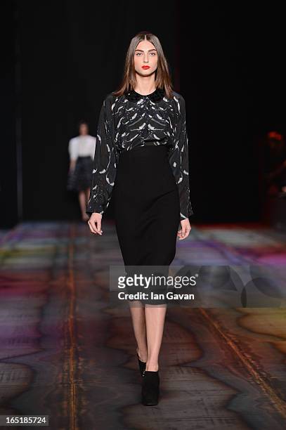 Model walks the runway at the Masha Kravtsova show during Mercedes-Benz Fashion Week Russia Fall/Winter 2013/2014 at Manege on April 1, 2013 in...