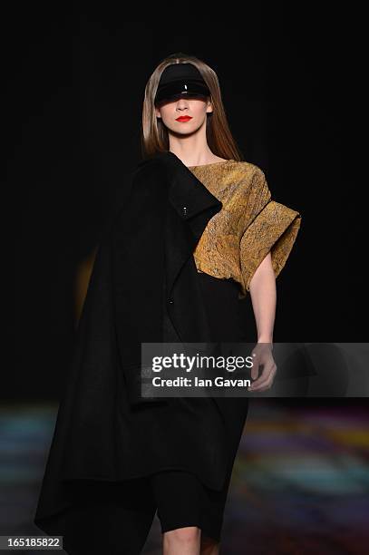 Model walks the runway at the Masha Kravtsova show during Mercedes-Benz Fashion Week Russia Fall/Winter 2013/2014 at Manege on April 1, 2013 in...