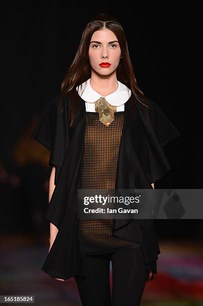 Model walks the runway at the Masha Kravtsova show during Mercedes-Benz Fashion Week Russia Fall/Winter 2013/2014 at Manege on April 1, 2013 in...