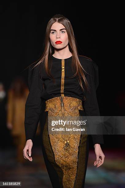 Model walks the runway at the Masha Kravtsova show during Mercedes-Benz Fashion Week Russia Fall/Winter 2013/2014 at Manege on April 1, 2013 in...