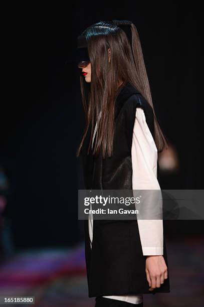 Model walks the runway at the Masha Kravtsova show during Mercedes-Benz Fashion Week Russia Fall/Winter 2013/2014 at Manege on April 1, 2013 in...