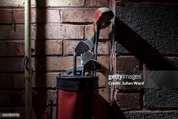 old golf clubs in a garage - golf club stock pictures, royalty-free photos & images