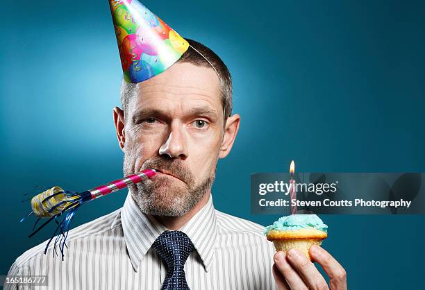 man wearing tie with party hat horn blower and cup - party horn blower bildbanksfoton och bilder