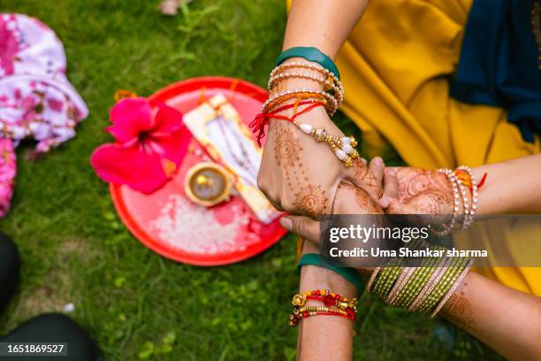 holding hands - rakhi stock pictures, royalty-free photos & images