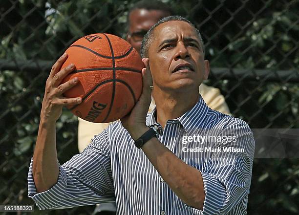 President Barack Obama plays basketball during the annual Easter Egg Roll on the White House tennis court April 1, 2013 in Washington, DC. Thousands...