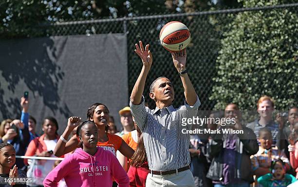 President Barack Obama plays basketball with children during the annual Easter Egg Roll on the White House tennis court April 1, 2013 in Washington,...