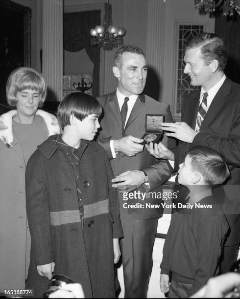 Harry Howell, Rangers defenseman and one of the coolest men on ice, accepts city's Bronz Medallion from Mayor John Lindsay at City Hall after playing...
