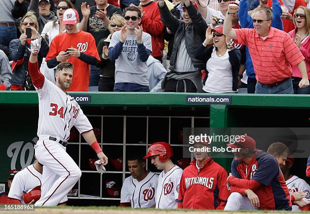 Bryce Harper of the Washington Nationals waves to the crowd after hitting a solo home run against the Miami Marlins during the fourth inning of their...