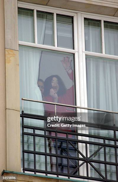 Singer Michael Jackson appears at the balcony of the Adlon Hotel November 19, 2002 in Berlin, Germany. Jackson is in Berlin with his three children...