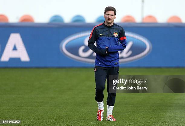 Lionel Messi warms up during the training session of Barcelona on the eve of the Champions League's quarter-final between Paris Saint-Germain and FC...