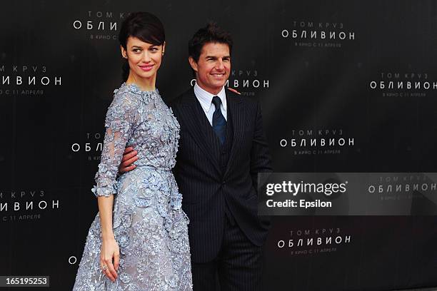 Olga Kurylenko and Tom Cruise attend the film premiere of 'Oblivion' at the Oktyabr cinema hall on April 1, 2013 in Moscow, Russia.