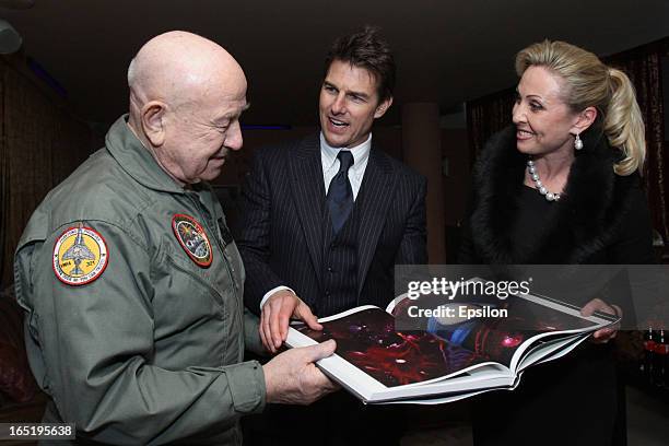 Legendary Russian astronaut Alexey Leonov presents to Tom Cruise his book before the film premiere of 'Oblivion' at the Oktyabr cinema hall on April...