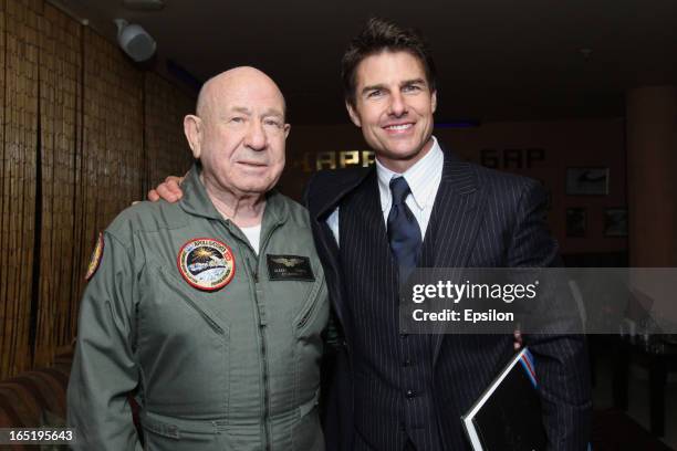 Legendary Russian astronaut Alexey Leonov presents to Tom Cruise his book before the film premiere of 'Oblivion' at the Oktyabr cinema hall on April...