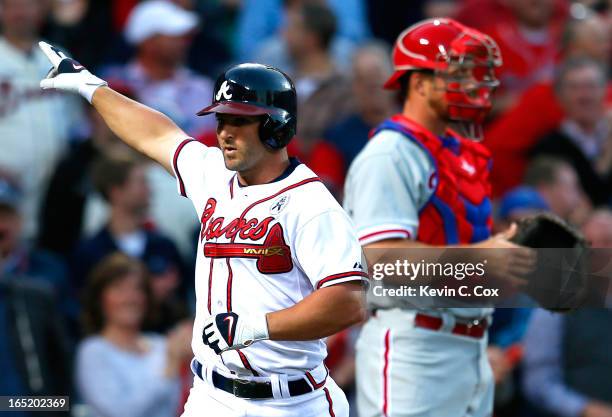 Dan Uggla of the Atlanta Braves reacts after a solo homer in the second inning against the Philadelphia Phillies during Opening Day at Turner Field...