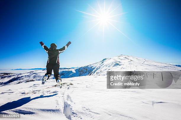 cheerful woman skier jumping in air on top - bad kleinkirchheim stock pictures, royalty-free photos & images