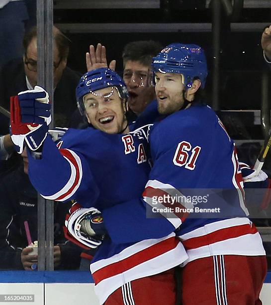 Derek Stepan of the New York Rangers scores his second goal of the game at 5:46 of the third period against the Winnipeg Jets and is joined by Rick...