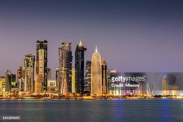 doha qatar by night - qatar stock pictures, royalty-free photos & images