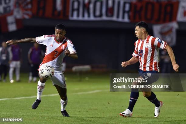 Peru's forward Andy Polo fights for the ball with Paraguay's defender Blas Riveros during the 2026 FIFA World Cup South American qualifiers football...