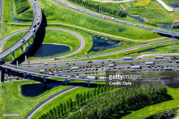 aerial shot of highway interchange - traffic stock pictures, royalty-free photos & images