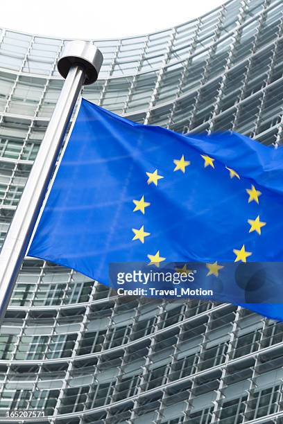 european flag in front of the berlaymont building in brussels - berlaymont stock pictures, royalty-free photos & images