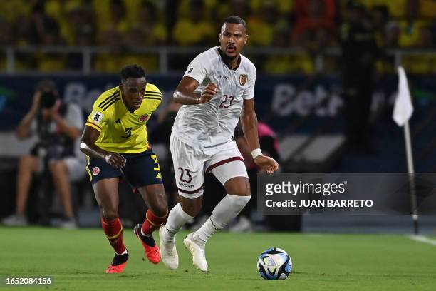 Venezuela's forward Salomon Rondon and Colombia's defender Jhon Lucumi fight for the ball during the 2026 FIFA World Cup South American qualifiers...