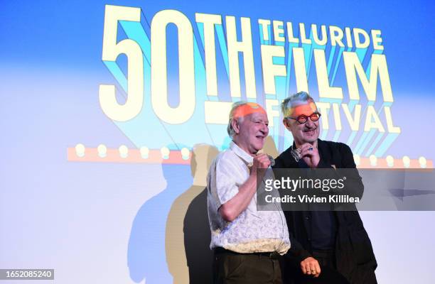Werner Herzog presents Wim Wenders with a silver medallion at the 50th Telluride Film Festival on August 31, 2023 in Telluride, Colorado.