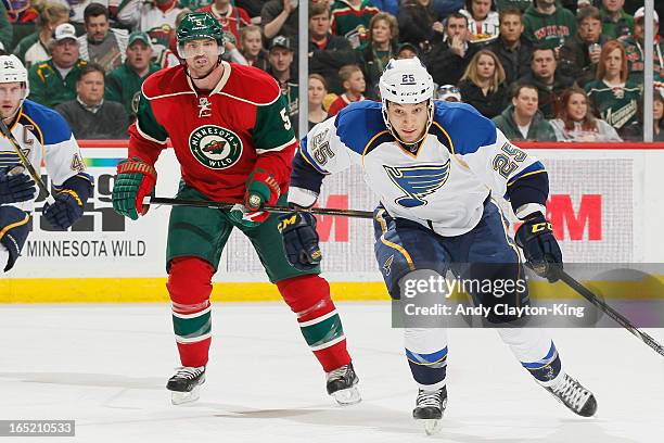 Chris Stewart of the St. Louis Blues and Brett Clark of the Minnesota Wild skate to the puck during the game on April 1, 2013 at the Xcel Energy...