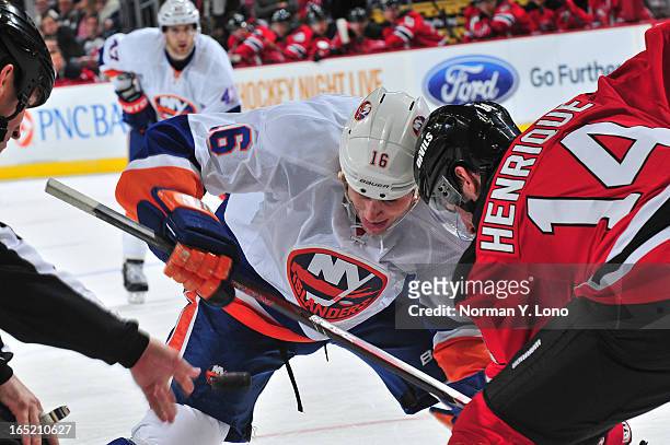Marty Reasoner of the New York Islanders battles Adam Henrique of the New Jersey Devils at the face at the Prudential Center on April 1, 2013 in...