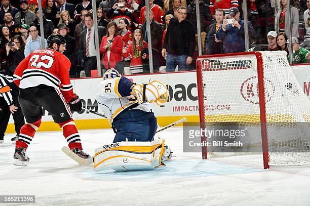 Michal Rozsival of the Chicago Blackhawks gets the puck past goalie Pekka Rinne of the Nashville Predators during the shoot-out to score the...