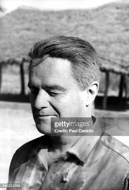 During an around-the-world trip to visit Peace Corps volunteers, Portrait of Peace Corps founder and president Sargent Shriver his face covered with...