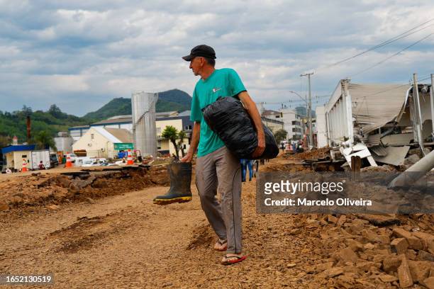 Resident affected by the flooding holds a bag as he looks for donations in the aftermath of the tropical cyclone on September 7, 2023 in Roca Sales,...