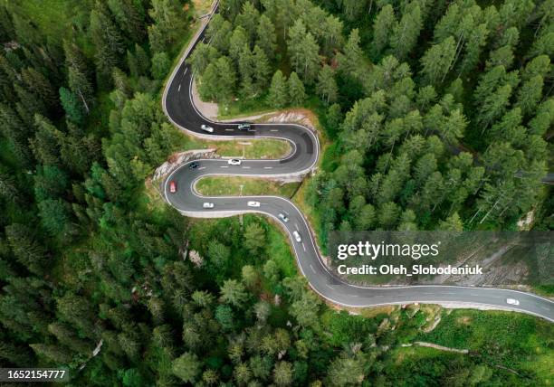 aerial view of car on the mountain road in switzerland - zwitserland stockfoto's en -beelden