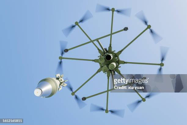 military drone dropping  bomb in blue sky - missile defense command stock pictures, royalty-free photos & images