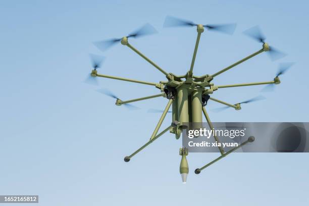 military drone dropping  bomb in blue sky - explosives fotografías e imágenes de stock