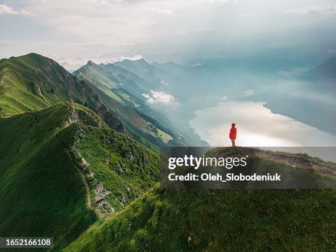 Aerial view of woman standing on top of the mountain ridge Augstmatthorn Aerial view of woman standing on top of the mountain ridge Augstmatthorn