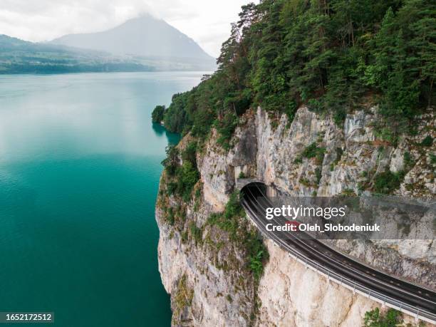 aerial view of road tunnel above interlaken lake - estrada de montanha imagens e fotografias de stock