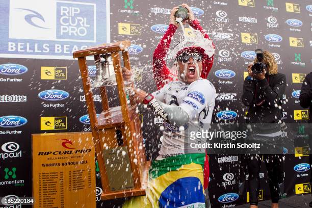 Adriano De Souza of Brasil rings the bell during prizegiving as Nat Young of the United States of America pours champaign over him at the Rip Curl...