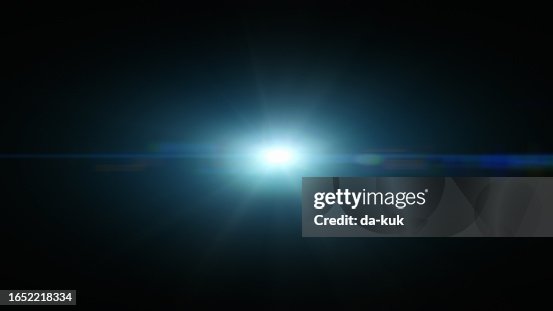 Blue lens flare overlay on black background design element Blue lens flare overlay on black background design element
